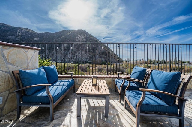 view of patio / terrace featuring a mountain view and a balcony