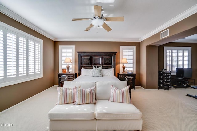 bedroom with crown molding, carpet floors, and ceiling fan