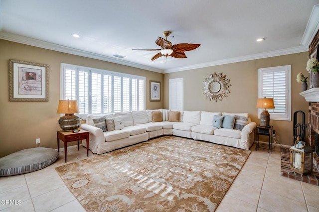 tiled living room featuring ceiling fan, crown molding, and a fireplace