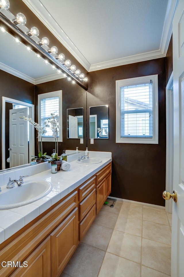 bathroom with crown molding, tile patterned flooring, a wealth of natural light, and vanity