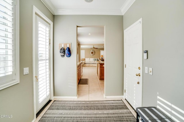 tiled foyer with crown molding and ceiling fan