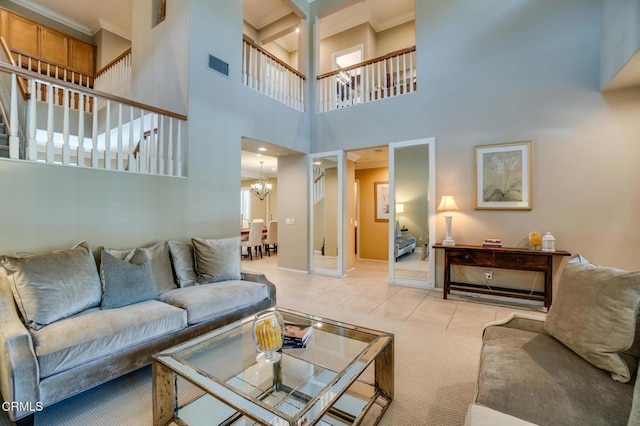 living room featuring an inviting chandelier, light colored carpet, a high ceiling, and ornamental molding