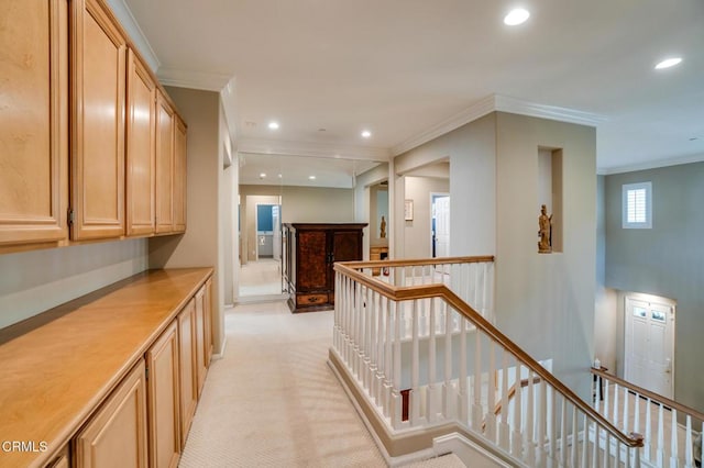 corridor with light colored carpet and crown molding