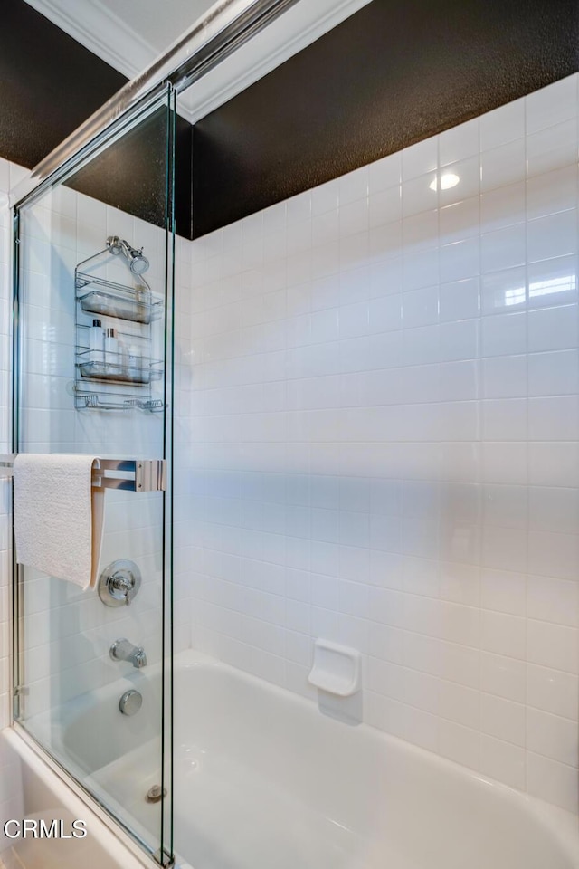 bathroom featuring shower / bath combination with glass door