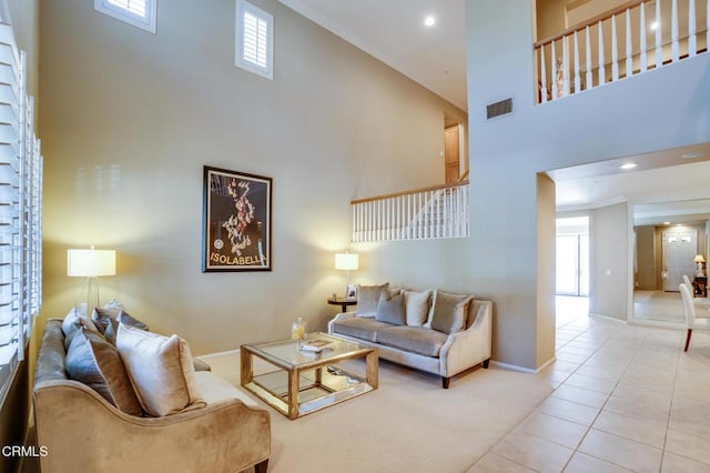 living room with a high ceiling and light tile patterned floors