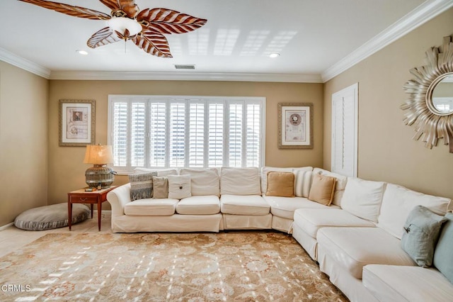 tiled living room featuring ceiling fan, ornamental molding, and a healthy amount of sunlight