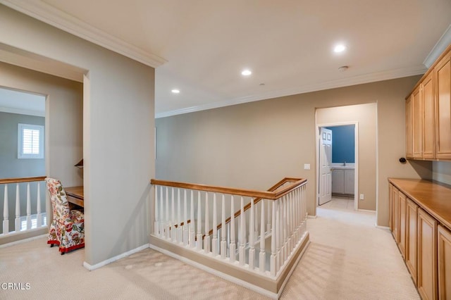 hall with crown molding and light carpet