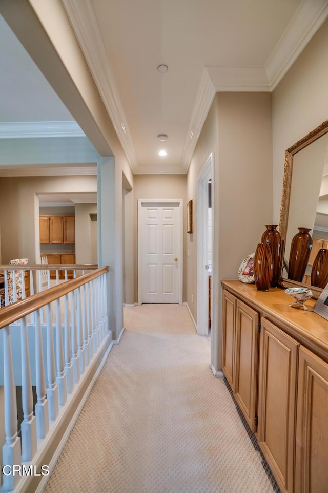 hallway with light colored carpet and ornamental molding