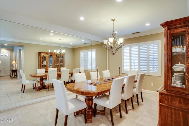 tiled dining space featuring a notable chandelier and ornamental molding