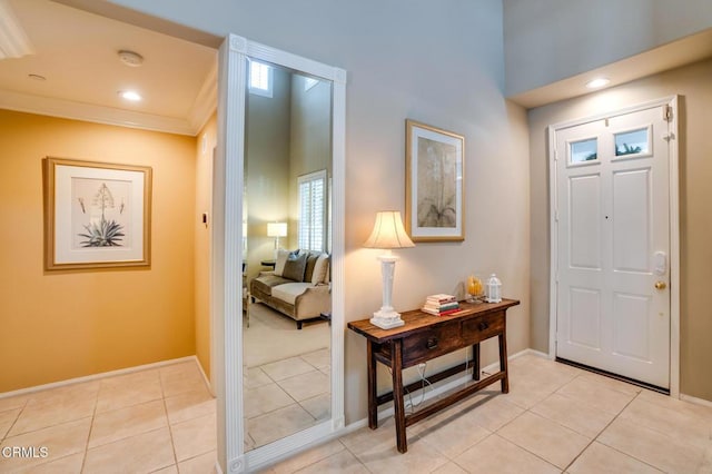 entryway featuring light tile patterned floors and ornamental molding