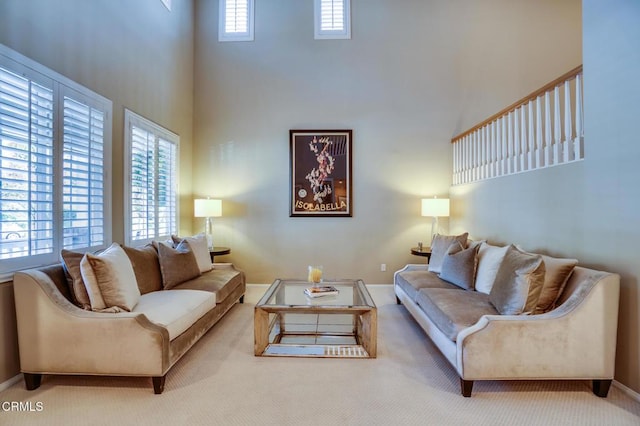 living room featuring a high ceiling and carpet