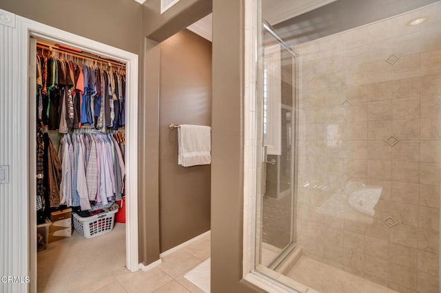 bathroom with walk in shower, tile patterned floors, and ornamental molding