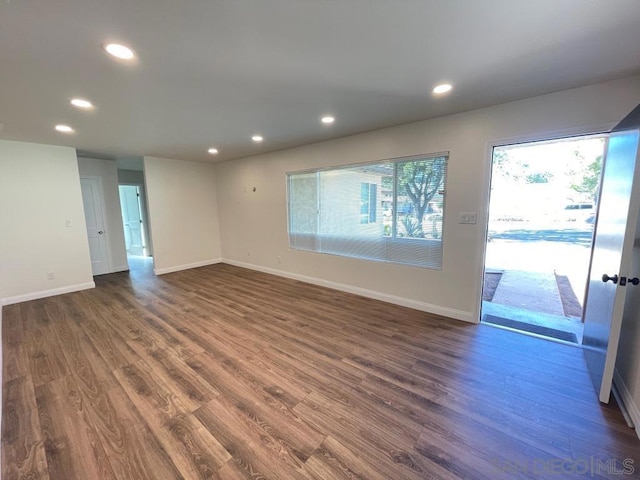 spare room featuring dark hardwood / wood-style flooring