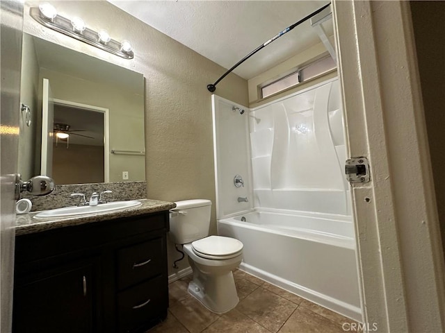 full bathroom with toilet, ceiling fan, washtub / shower combination, a textured ceiling, and vanity