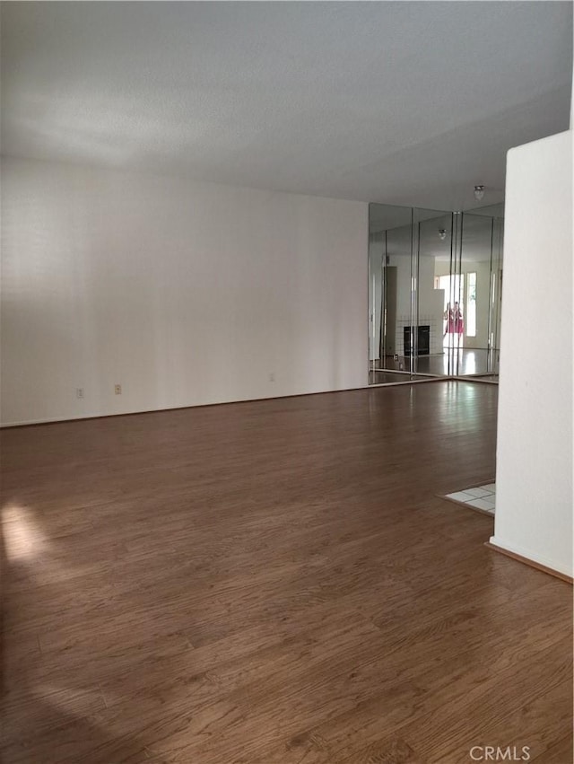 empty room with dark hardwood / wood-style floors