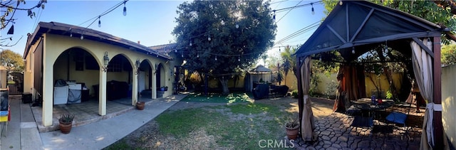 view of side of property featuring a patio area and a yard