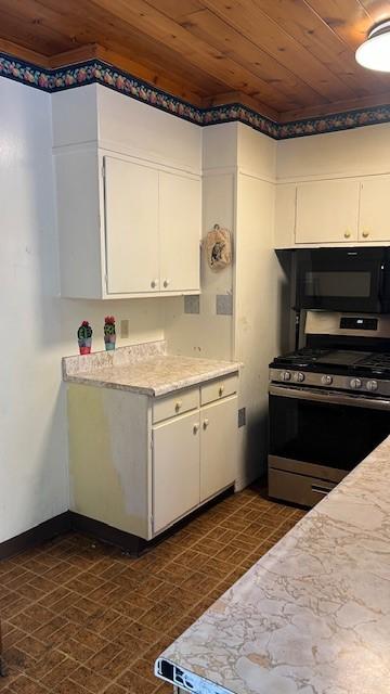 kitchen featuring white cabinetry, stainless steel gas range, and wood ceiling