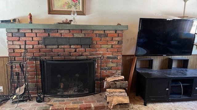 interior details with a fireplace and wood walls