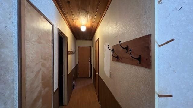 corridor with wood ceiling and hardwood / wood-style floors