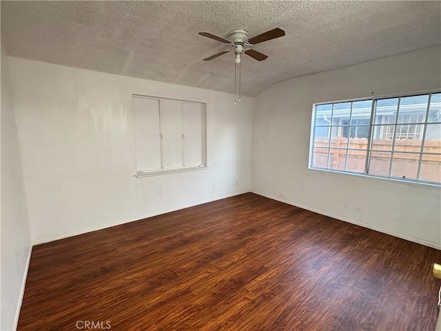 spare room with ceiling fan, dark hardwood / wood-style flooring, and a textured ceiling