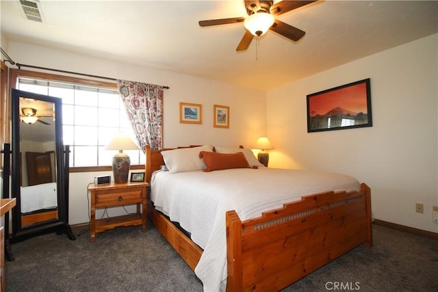 bedroom with ceiling fan and dark colored carpet