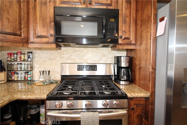 905 Madera Ln, Lake Arrowhead, CA 92352 - kitchen featuring stainless steel appliances, backsplash, brown cabinetry, and light stone countertops
