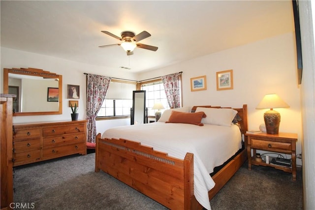 bedroom featuring ceiling fan and dark colored carpet