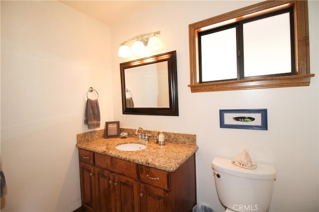 bathroom with toilet and vanity