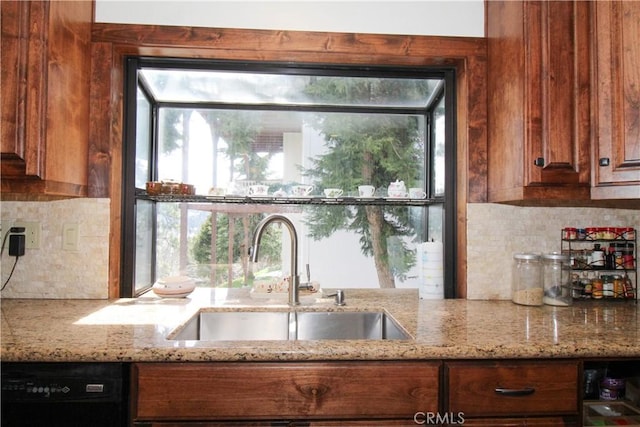905 Madera Ln, Lake Arrowhead, CA 92352 - kitchen featuring light stone counters, backsplash, a sink, brown cabinets, and black dishwasher