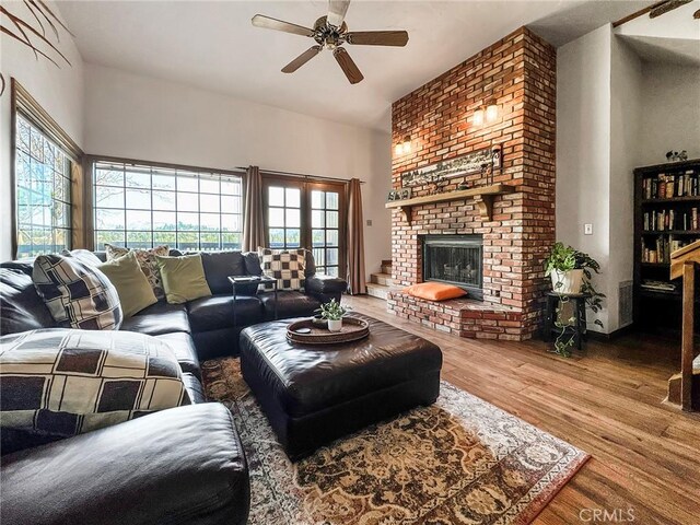 905 Madera Ln, Lake Arrowhead, CA 92352 - living room featuring a high ceiling, wood finished floors, a brick fireplace, and ceiling fan