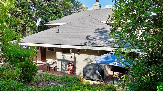 905 Madera Ln, Lake Arrowhead, CA 92352 - back of house featuring a shingled roof, a chimney, and a wooden deck