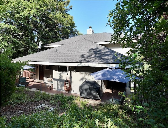 905 Madera Ln, Lake Arrowhead, CA 92352 - rear view of house with roof with shingles, a wooden deck, and a chimney