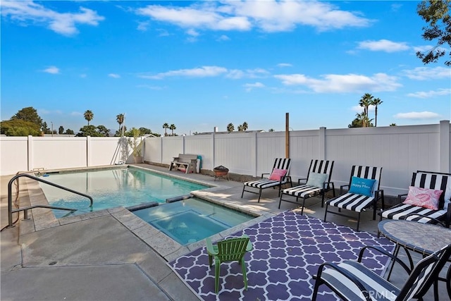 view of swimming pool with an in ground hot tub and a patio area