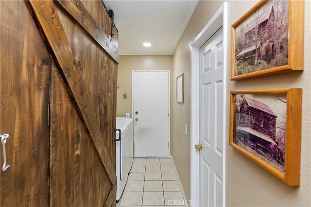 interior space with light tile patterned floors and a barn door