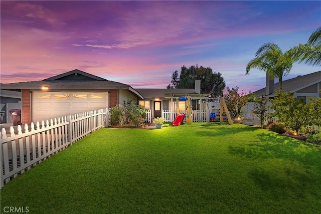 single story home with a lawn, a playground, and a garage