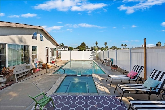 view of swimming pool with a patio and an in ground hot tub