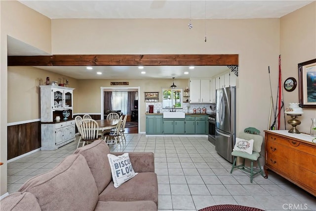 living room featuring sink and light tile patterned floors