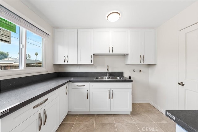 kitchen with sink, white cabinetry, and light tile patterned floors