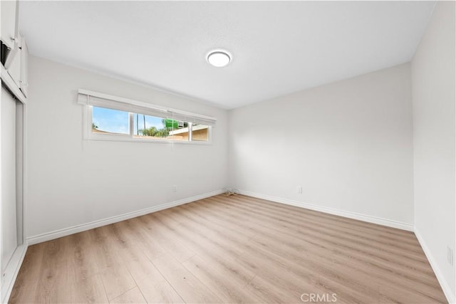 empty room with light hardwood / wood-style flooring