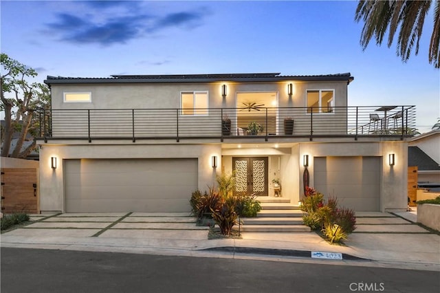 view of front facade with a garage and a balcony