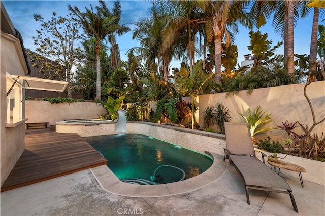 view of swimming pool with an in ground hot tub