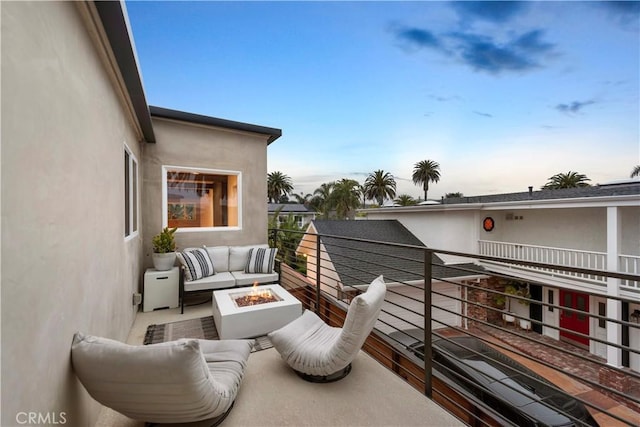 balcony at dusk with an outdoor fire pit