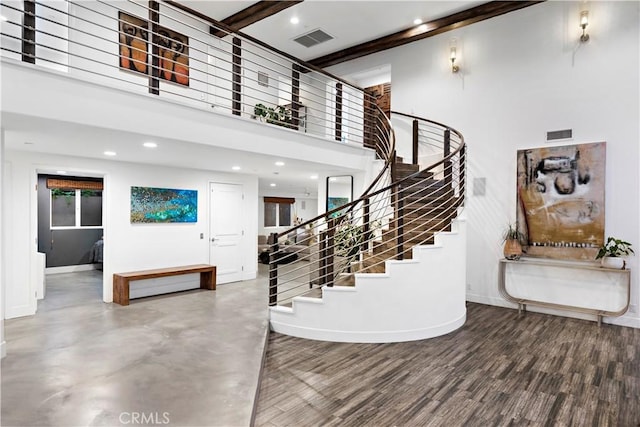 foyer featuring hardwood / wood-style flooring, a high ceiling, and beamed ceiling