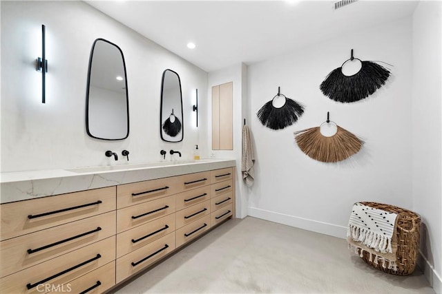 bathroom featuring concrete floors and vanity