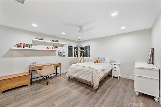 bedroom with ceiling fan and light hardwood / wood-style flooring