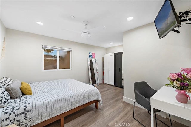 bedroom featuring ceiling fan and light hardwood / wood-style flooring