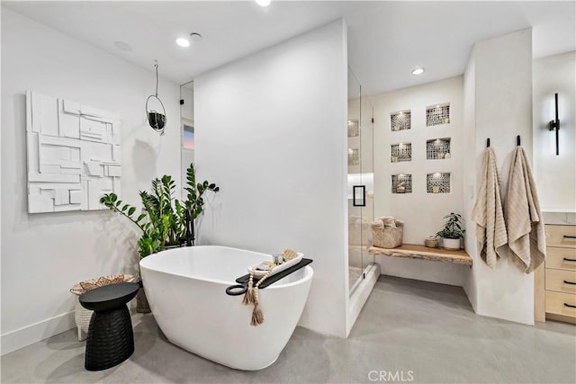 bathroom featuring concrete flooring and separate shower and tub