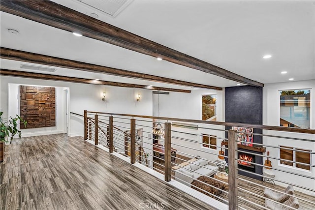 hallway featuring beam ceiling and wood-type flooring