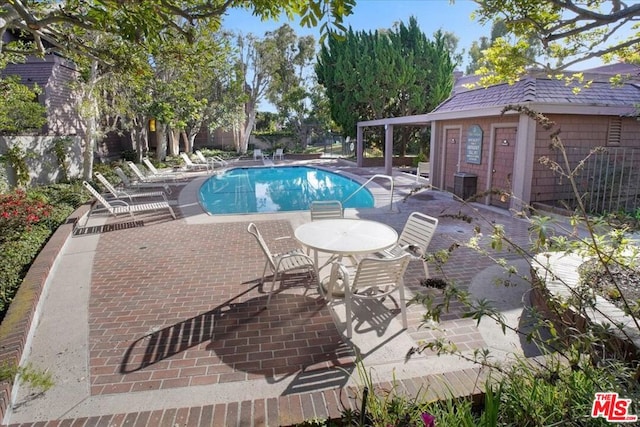 view of swimming pool featuring a patio area and cooling unit