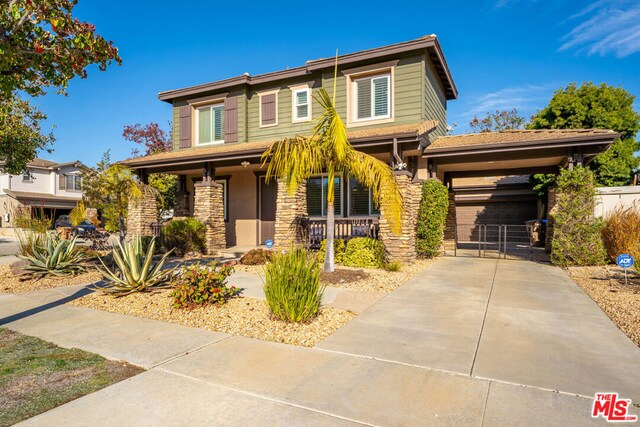 view of front of house with covered porch and a garage